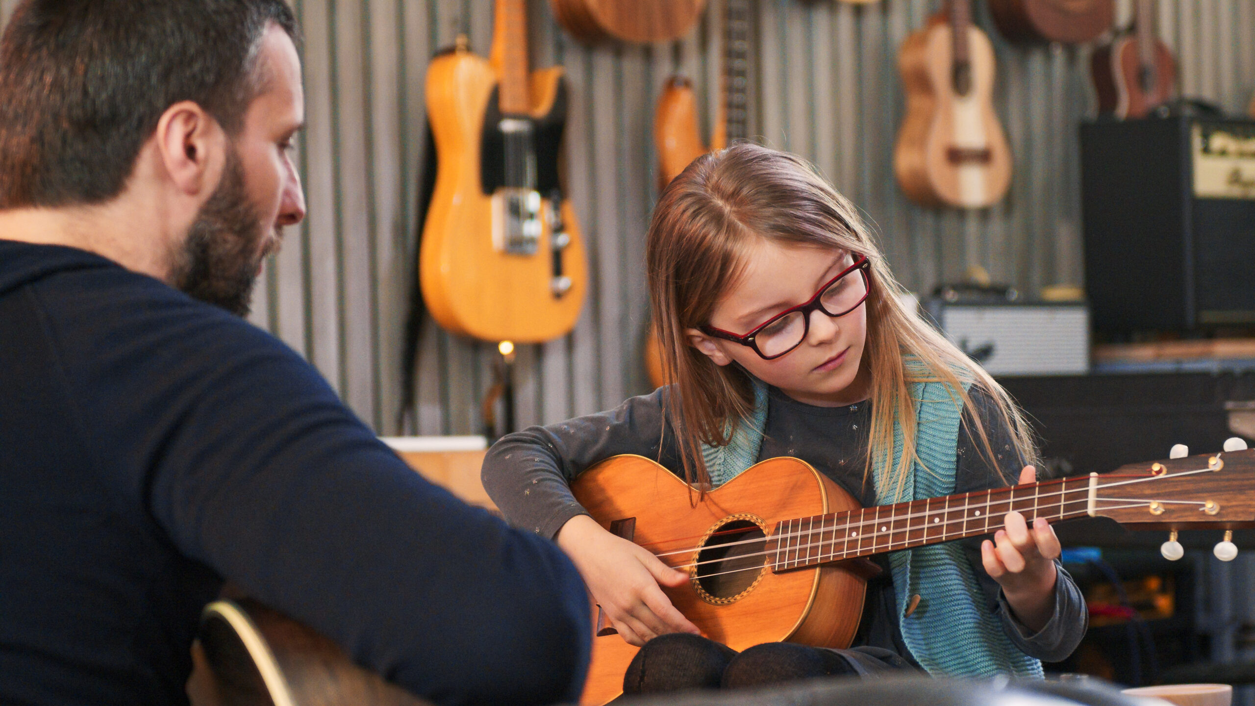 Child taking ukelele lessons