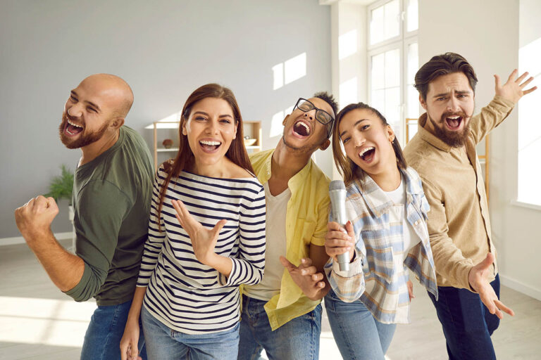 friends singing their favorite songs together on karaoke microphone during home party