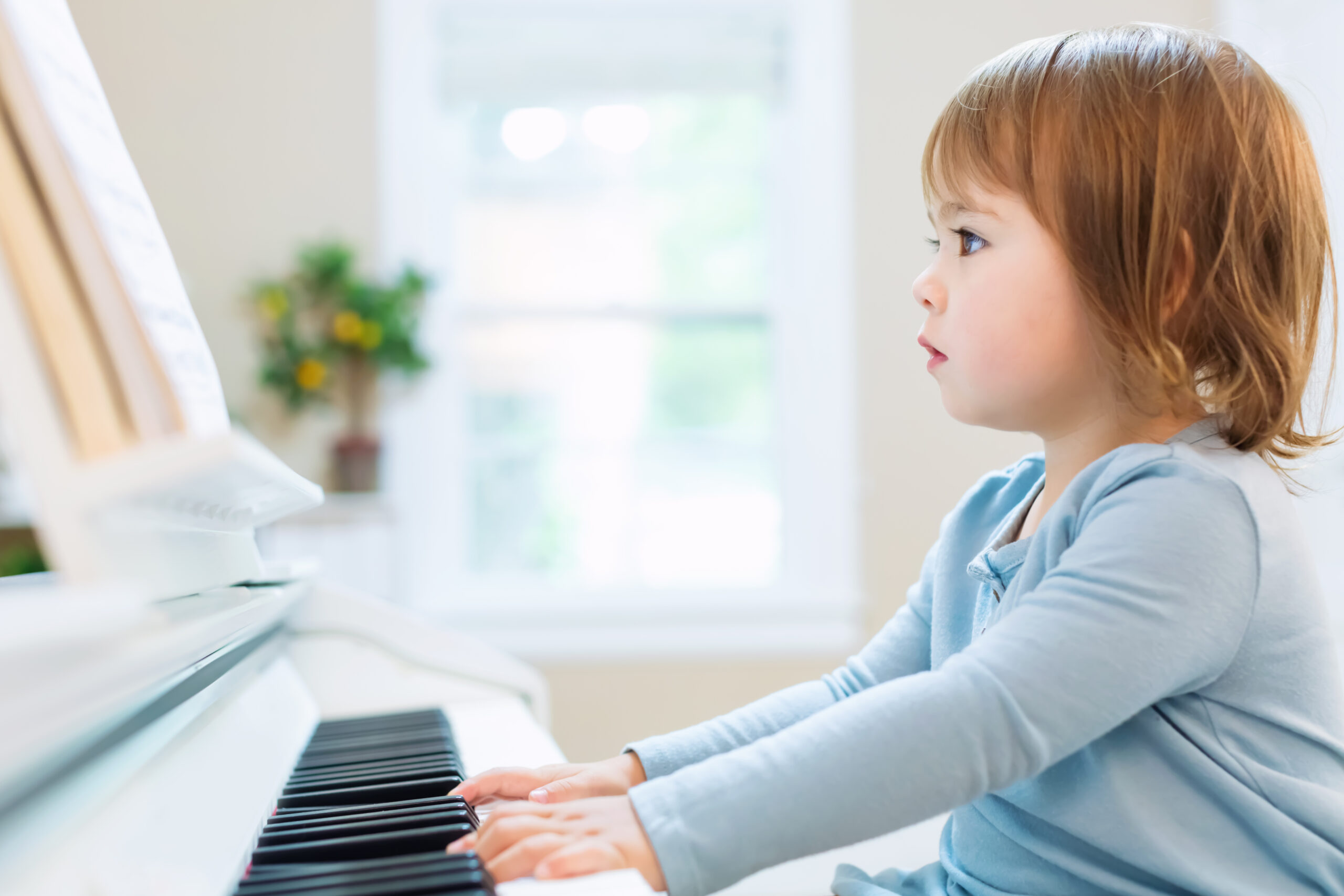 Toddler girl playing piano