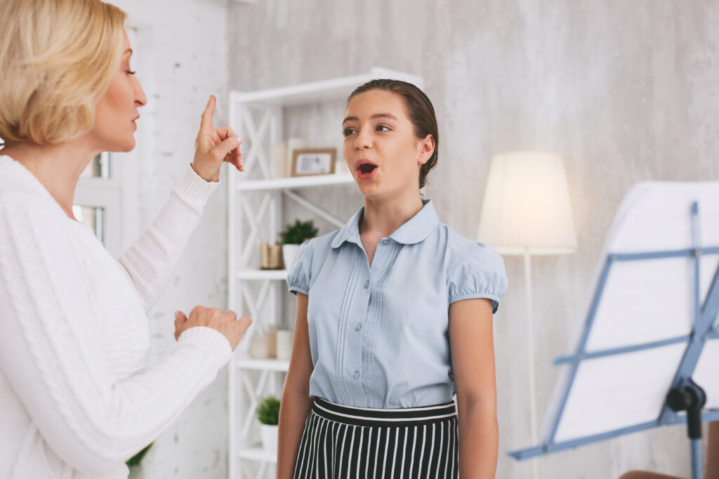 Teenager with teacher taking voice lessons