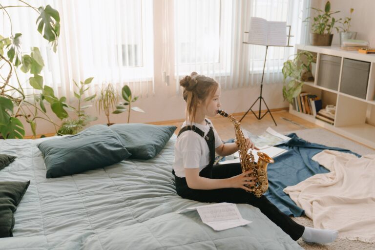 girl playing the saxaphone on her bed