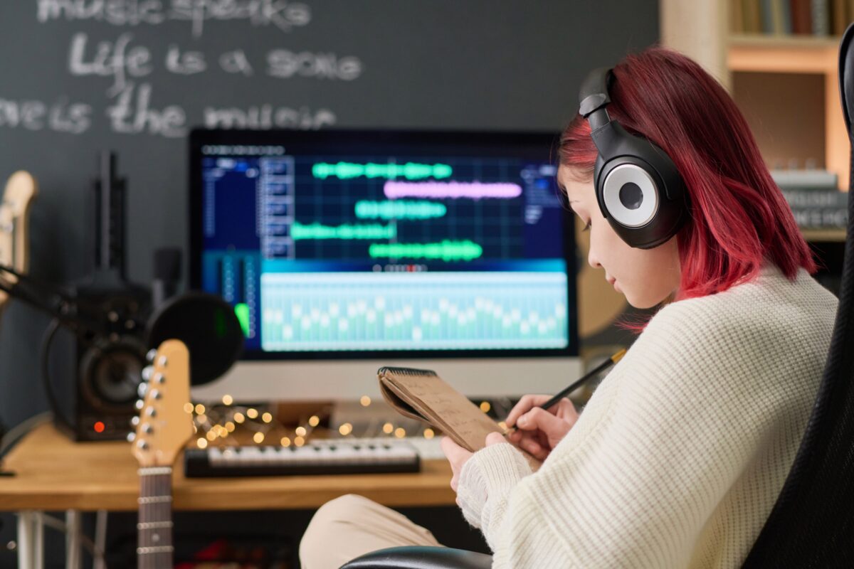 Teenager creating music at her computer